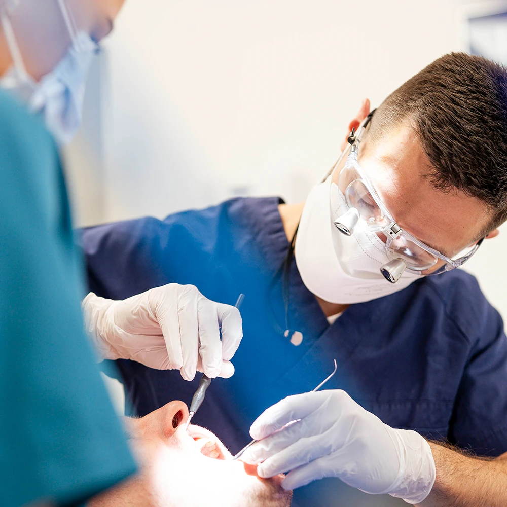 Zahnärztliches Team setzt eine Zahnfüllung am Patienten in der Praxis Karlstadt am Main.